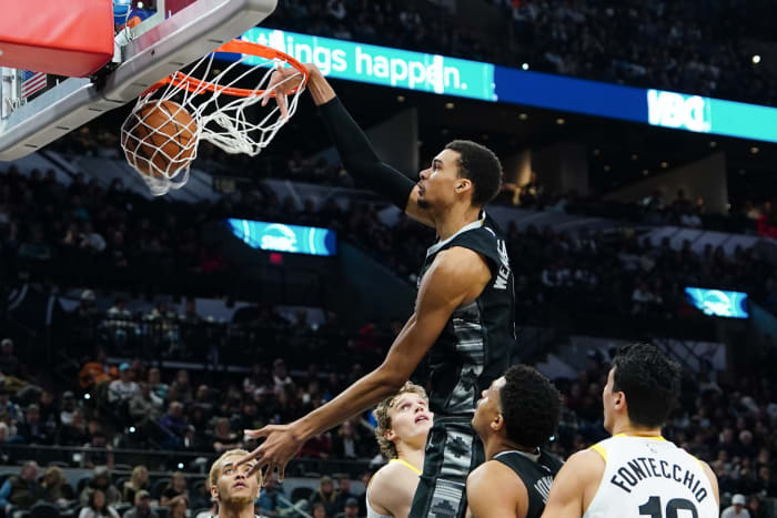 Dec 26, 2023; San Antonio, Texas, USA; San Antonio Spurs center Victor Wembanyama (1) dunks in front of Utah Jazz forward Lauri Markkanen (23) in the second half at Frost Bank Center.